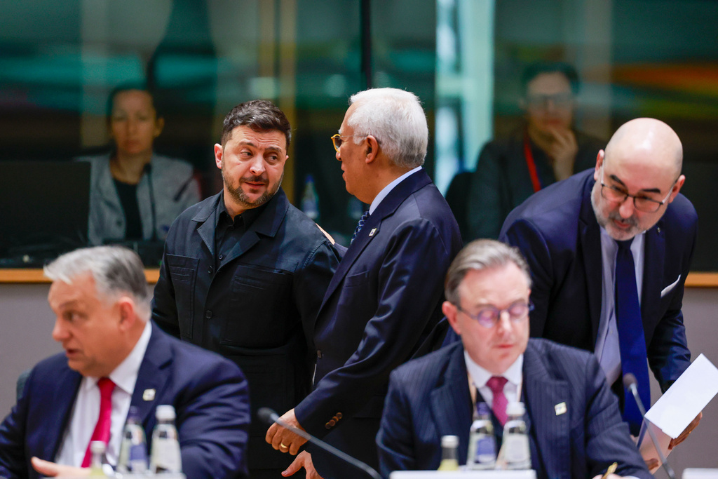 Ukraine's President Volodymyr Zelenskyy, second left, speaks with European Council President Antonio Costa, center rear, during a round table meeting at the EU Summit in Brussels, Thursday, Dec. 18, 2025. (Stephanie Lecocq, Pool Photo via AP)