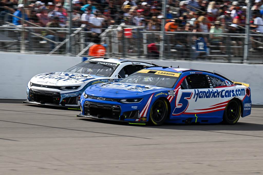Kyle Larson (5) and Ross Chastain (1) race during a NASCAR Cup Series auto race Sunday, Sept. 13, 2026, in Madison, Ill. (AP Photo/Connor Hamilton)