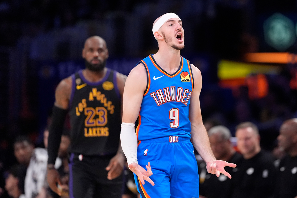 Oklahoma City Thunder guard Alex Caruso, celebrates after scoring as Los Angeles Lakers forward LeBron James stands behind during the first half of Game 4 in a second-round NBA basketball playoffs series Monday, May 11, 2026, in Los Angeles. (AP Photo/Mark J. Terrill)