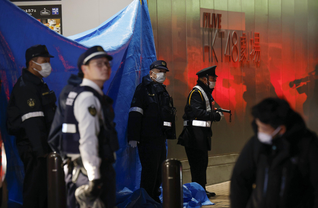 Police guard near the site of a stabbing at a facility in Fukuoka, western Japan, Sunday, Dec. 14, 2025. (Kyodo News via AP)