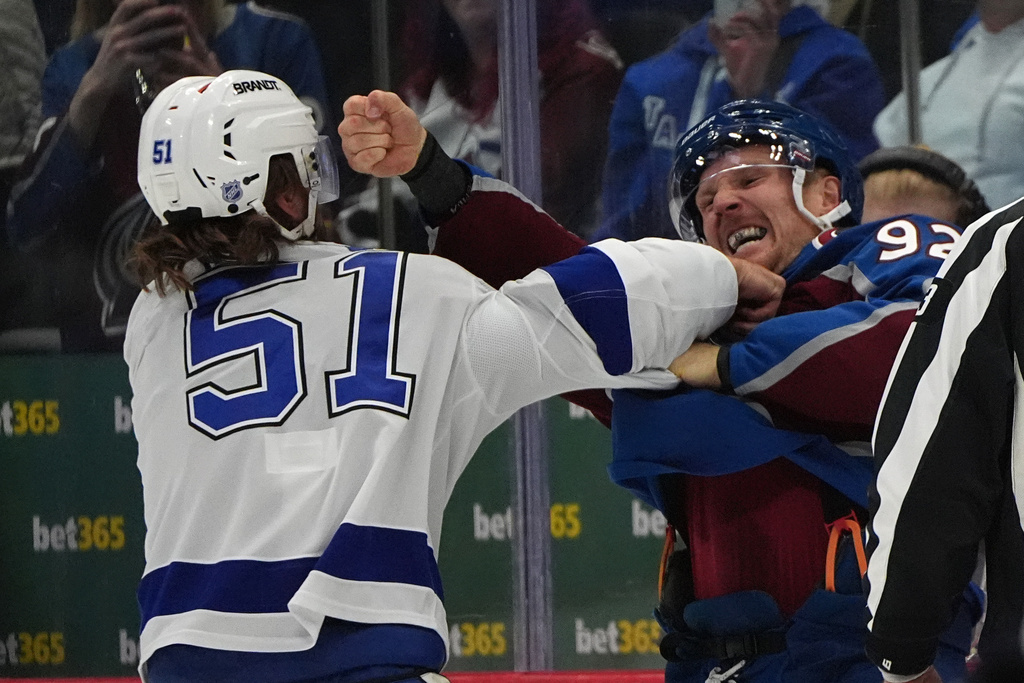 Tampa Bay Lightning defenseman Charle-Edouard D'Astous, left, holds off Colorado Avalanche left wing Gabriel Landeskog as he throws a punch during a brief dustup in the first period of an NHL hockey game Tuesday, Nov. 4, 2025, in Denver. (AP Photo/David Zalubowski)
