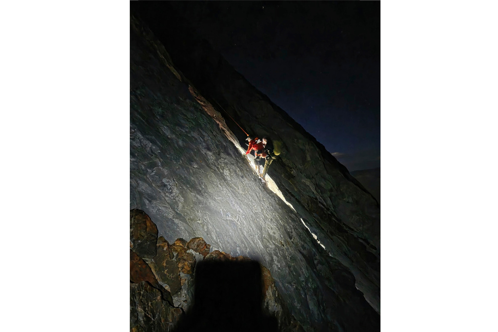This photo released by Mono County Sheriff Search and Rescue, shows a rescuer with the man who was stranded, Rob Martin, right, after he was rescued on a ledge in the Sierra Nevada, Calif., on Aug. 22, 2026. (Mono County Sheriff Search and Rescue via AP)