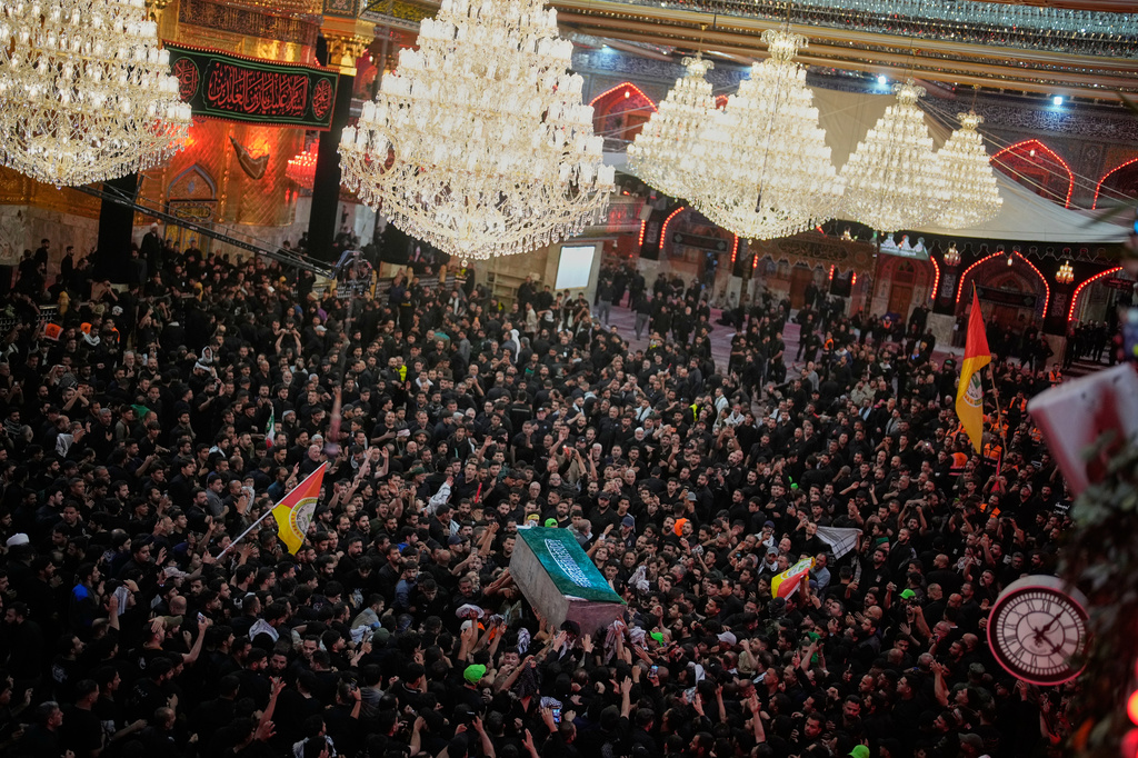 The coffin of the late Iranian Supreme Leader Ayatollah Ali Khamenei is carried through a crowd of mourners at the Imam Hussein Shrine in Karbala, Iraq, early Thursday, July 9, 2026. (AP Photo/Khalil Hamra)