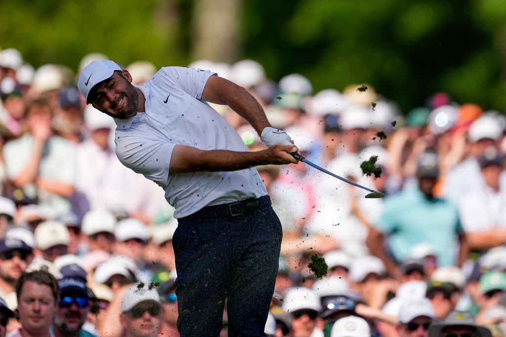 Scottie Scheffler hits his tee shot on the 12th hole during the final round of the Masters golf tournament at the Augusta National Golf Club, Sunday, April 12, 2026, in Augusta, Ga. (AP Photo/Gerald Herbert)