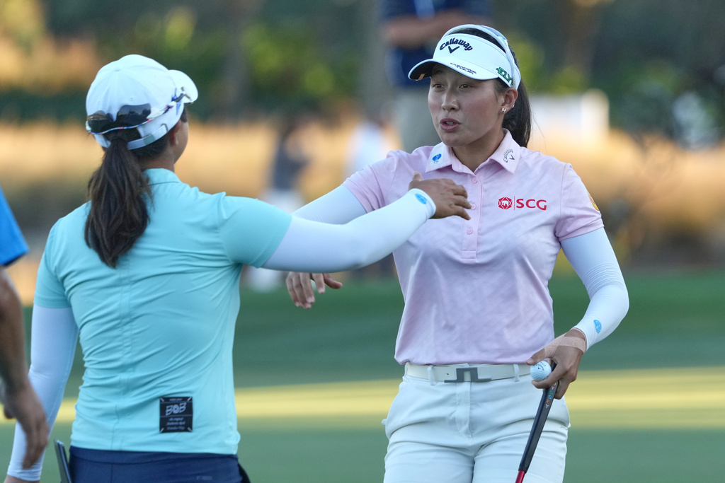 Jeeno Thitikul of Thailand, right, and Sei Young Kim of South Korea talk at the end of the second round of the LPGA Tour Championship golf tournament, Friday, Nov. 21, 2025, in Naples, Fla. (AP Photo/Marta Lavandier)
