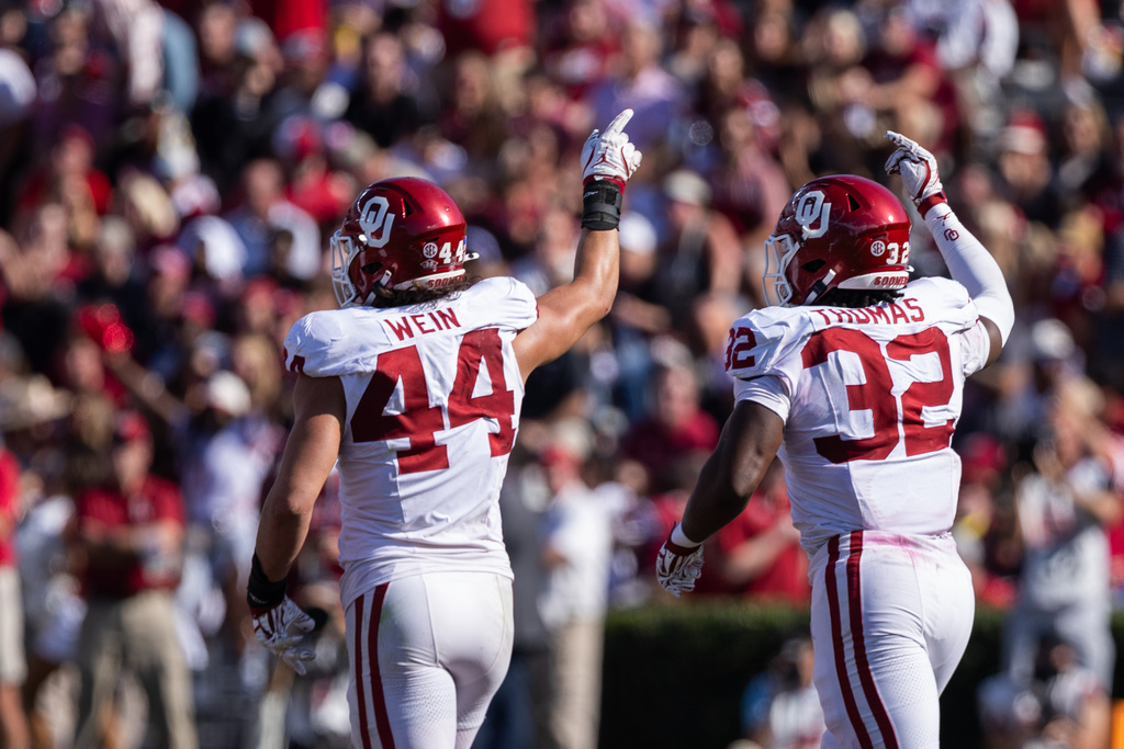Oklahoma defensive lineman Taylor Wein (44) and defensive lineman R Mason Thomas (32) celebrate after an interception against South Carolina in an NCAA college football game Saturday, Oct. 18, 2025, in Columbia, S.C. (AP Photo/Scott Kinser)