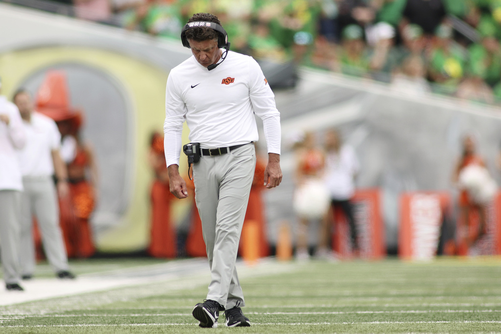 Oklahoma State head coach Mike Gundy walks on the field during the first half of an NCAA college football game, Saturday, Sept. 6, 2025, in Eugene, Ore. (AP Photo/Lydia Ely)