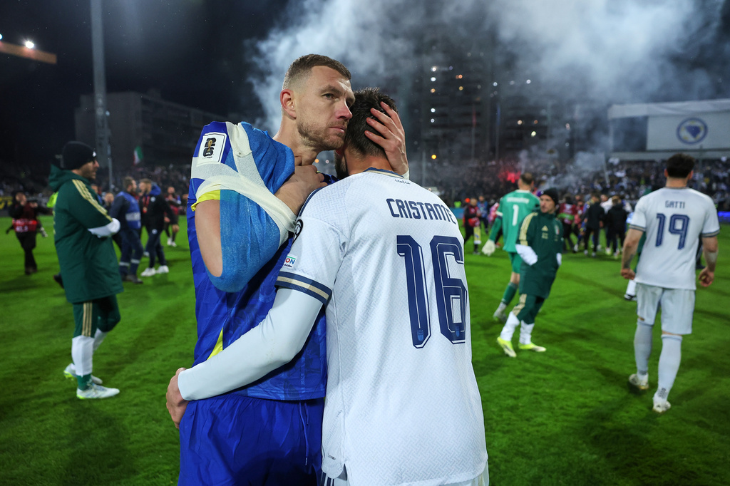 Bosnia's Edin Dzeko, left, greets Italy's Bryan Cristante after a penalty shootout during the World Cup qualifying playoff final soccer match between Bosnia and Italy in Zenica, Bosnia, Tuesday, March 31, 2026. (AP Photo/Armin Durgut)