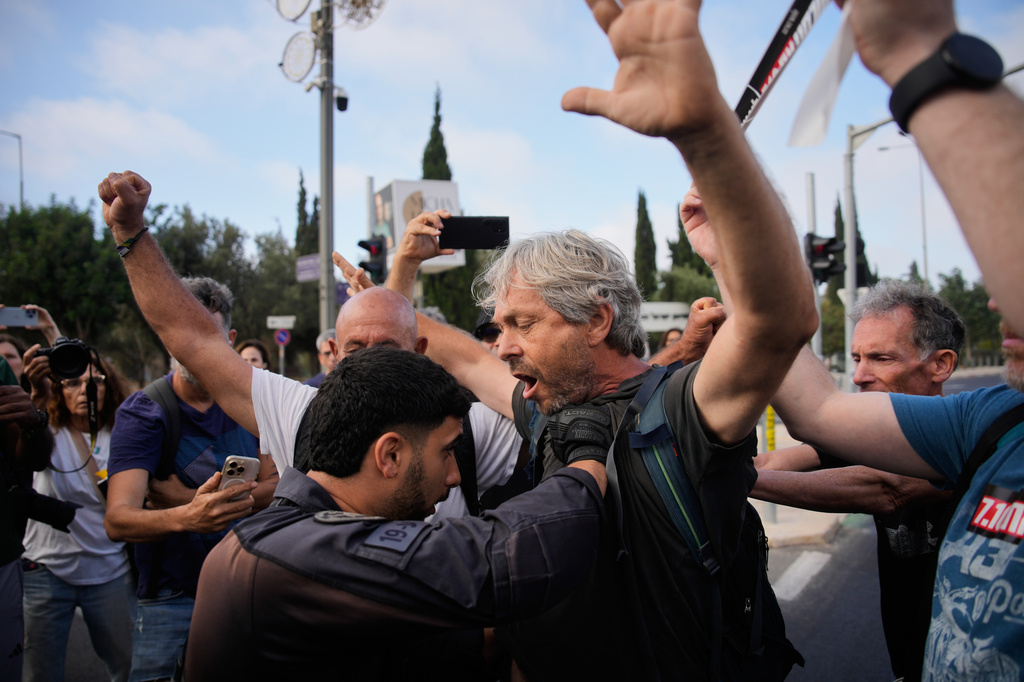 Police disperse demonstrators during a protest marking 1,000 days since the Oct. 7 2003 Hamas-led attack on Israel, outside of the Knesset, Israel's parliament, in Jerusalem, Thursday, July 2, 2026. (AP Photo/Ohad Zwigenberg)