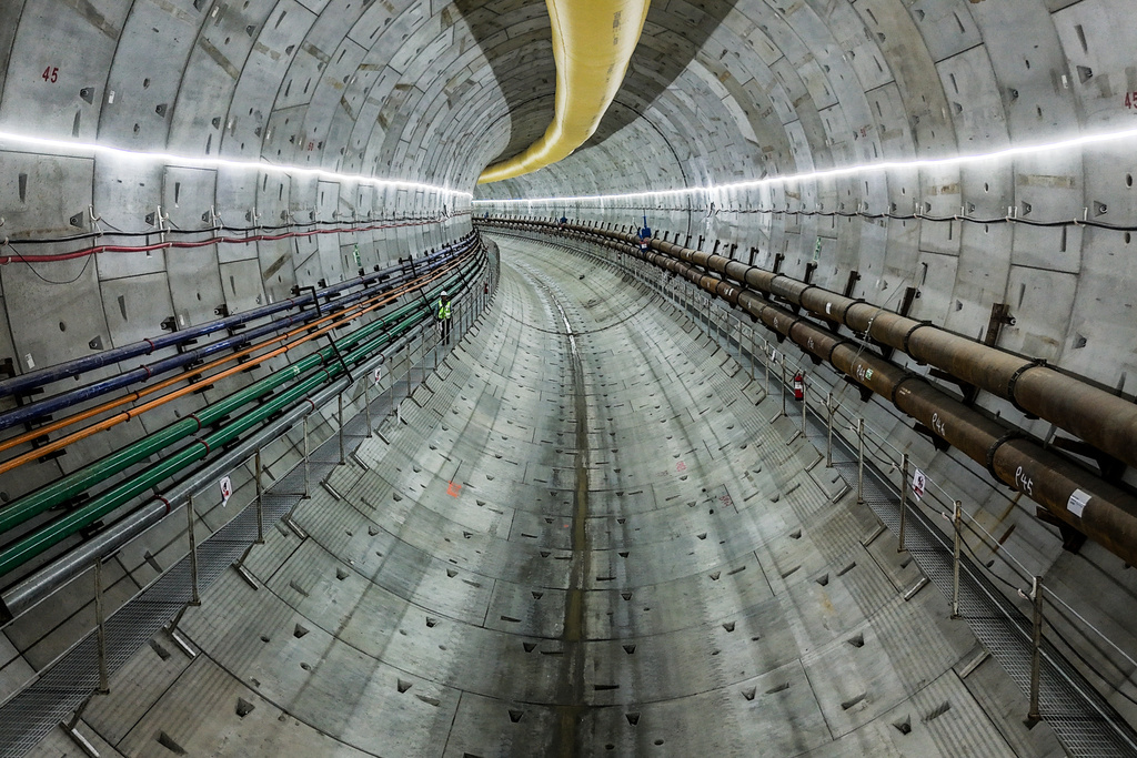 A construction worker makes his way along a track-level walkway in the metro tunnel beneath the Panama Canal during a media tour, in Arraijan, west of Panama City, Tuesday, Sept. 23, 2025. (AP Photo/Matias Delacroix)
