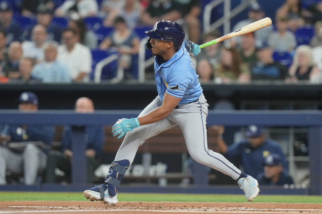 Tampa Bay Rays' Richie Palacios hits a triple to center field during the first inning of a baseball game against the Miami Marlins Friday, June 5, 2026, in Miami. (AP Photo/Marta Lavandier)