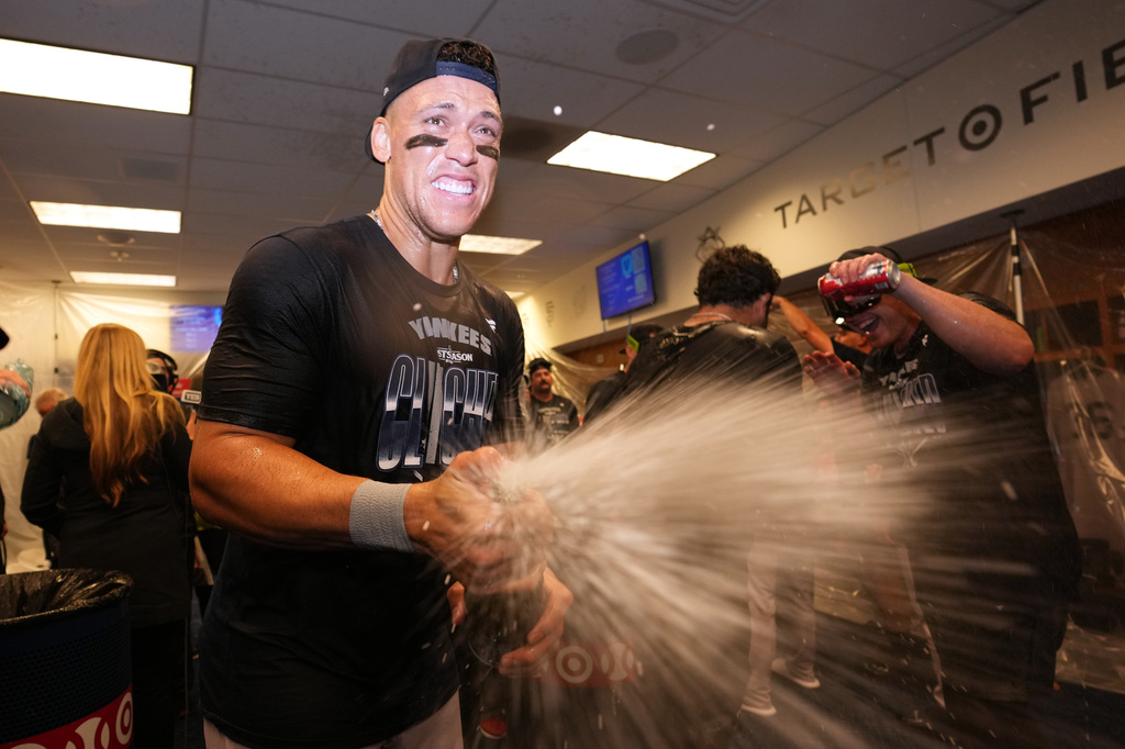 New York Yankees' Aaron Judge celebrates with teammates after they clinched the playoffs in a baseball game against the Minnesota Twins, Monday, Sept. 14, 2026, in Minneapolis. (AP Photo/Abbie Parr)