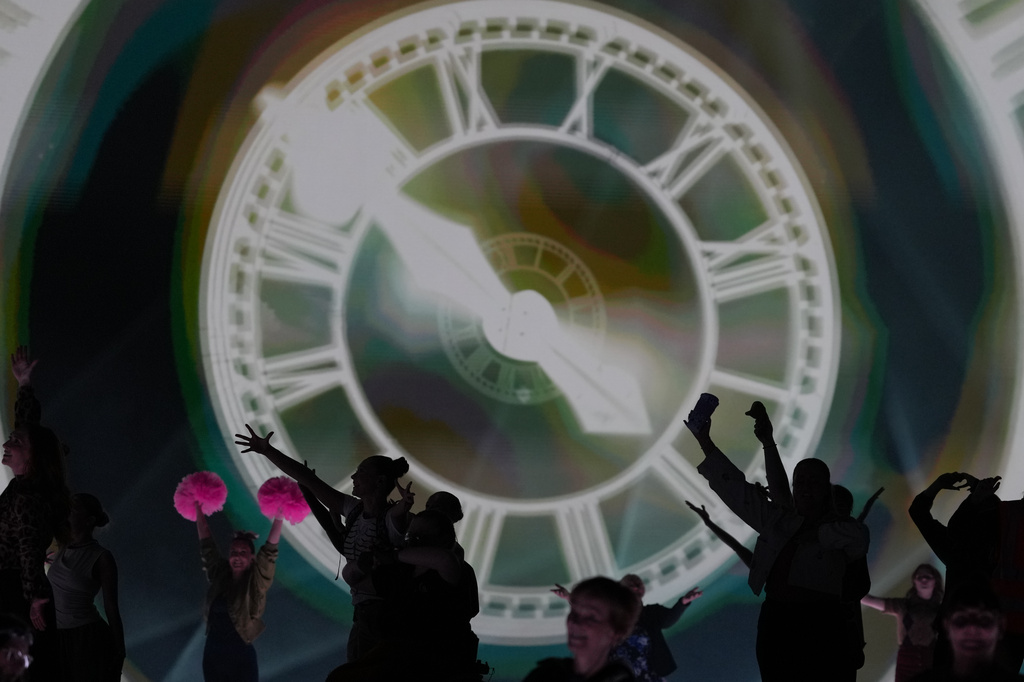 FILE - Performers celebrate the Glasgow Central railway station clock during the Commonwealth Games opening ceremony in Glasgow, Scotland, July 23, 2026. (AP Photo/Kin Cheung, File)