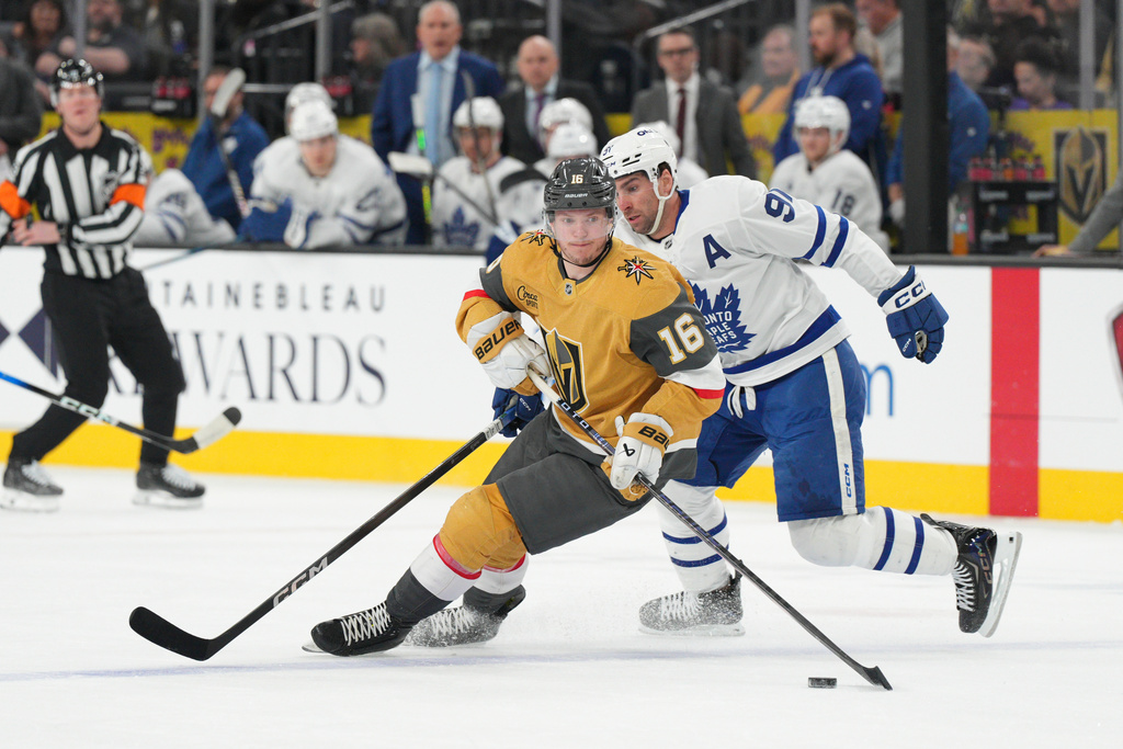 Vegas Golden Knights right wing Pavel Dorofeyev (16) skates with the puck against Toronto Maple Leafs center John Tavares, right, during the first period of an NHL hockey game Thursday, Jan. 15, 2026, in Las Vegas. (AP Photo/Candice Ward)