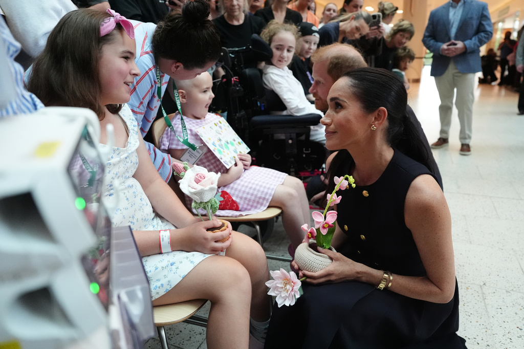 Britain's Prince Harry and Meghan Markle, the Duke and Duchess of Sussex, meet patients and their family members during a visit to the Royal Children's Hospital Melbourne, Australia Tuesday, April 14, 2026. (Jonathan Brady/Pool Photo via AP)