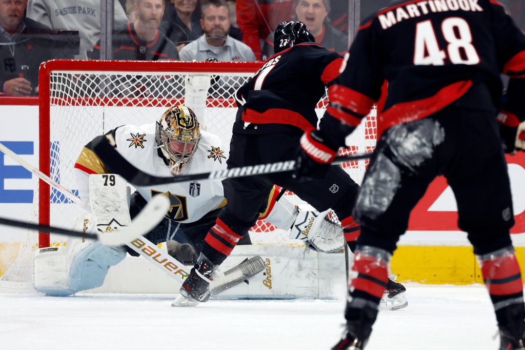 Carolina Hurricanes' Nikolaj Ehlers (27) slips the puck past Vegas Golden Knights goaltender Carter Hart (79) for a goal during the first period in Game 1 of the NHL hockey Stanley Cup Final series in Raleigh, N.C., Tuesday, June 2, 2026. (AP Photo/Karl DeBlaker)