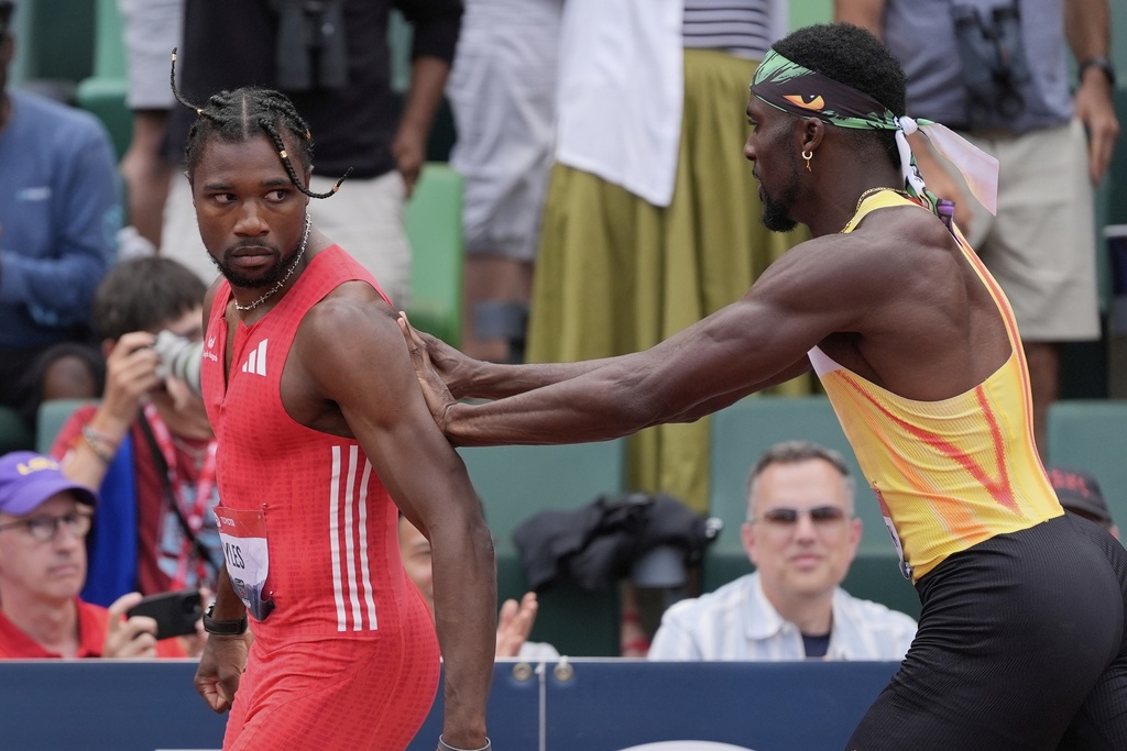 FILE - Kenny Bednarek pushes Noah Lyles after the men's 200-meter finals during the U.S. Championships athletics meet in Eugene, Ore., on Aug. 3, 2025. (AP Photo/Ashley Landis, File)
