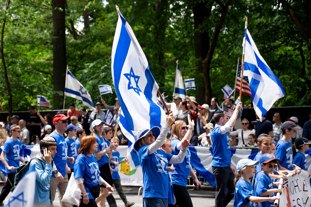 Parade participants wave flags to the crowd during the Israel Day Parade, Sunday, May 31, 2026, in New York. (AP Photo/Emil T. Lippe)