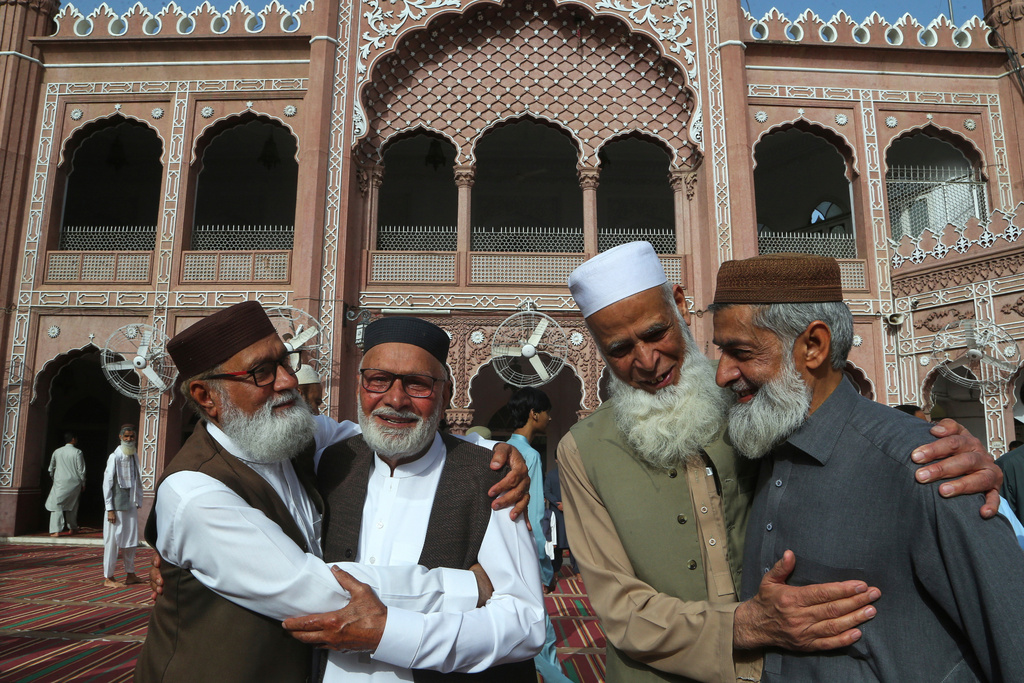 FILE - Muslims share Eid al-Fitr greeting after attending Eid prayer, marking the end of the Muslim's holy fasting month of Ramadan, at the historical Sunehri Mosque, in Peshawar, Pakistan, March 31, 2025. (AP Photo/Muhammad Sajjad, File)
