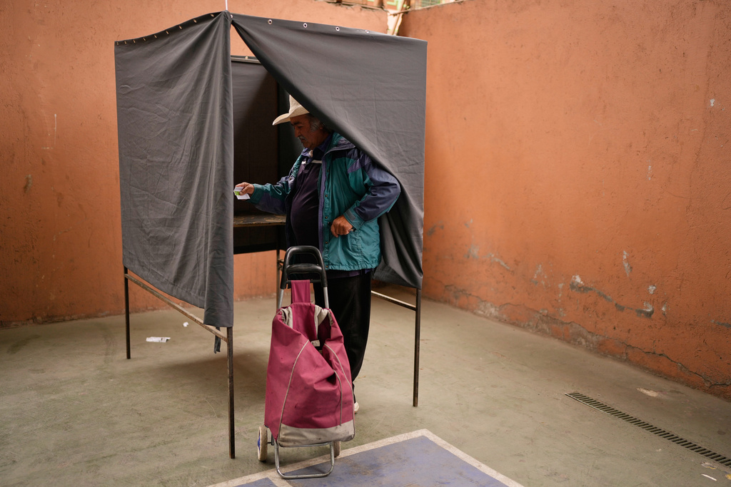 Luis Soto prepares to vote in the presidential runoff election in Santiago, Chile, Sunday, Dec. 14, 2025. (AP Photo/Natacha Pisarenko)