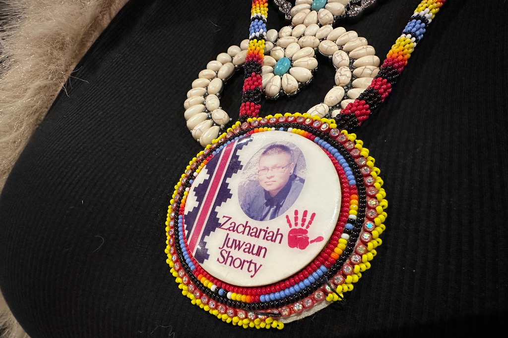 Vangie Randall-Shorty wears a button in memory of her son Zachariah Shorty in Bernalillo, New Mexico, Nov. 24, 2025. (AP Photo/Susan Montoya Bryan)