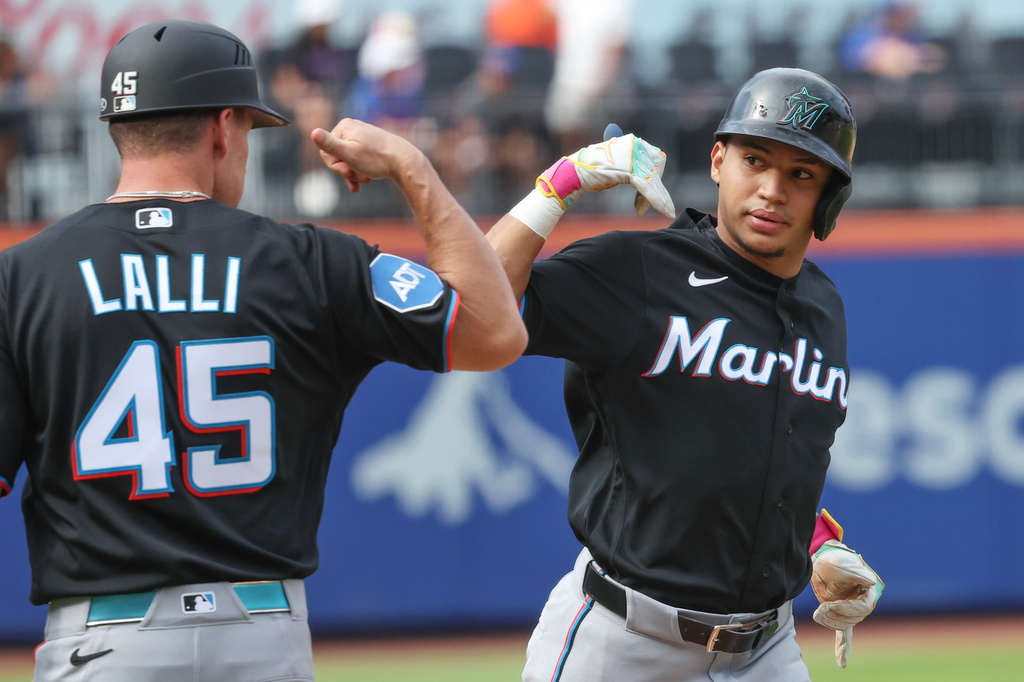 Miami Marlins' Javier Sanoja, right, gestures with third base coach Blake Lalli (45) after hitting a home run during the second inning of a baseball game against the New York Mets, Saturday, Aug. 1, 2026, in New York. (AP Photo/Heather Khalifa)