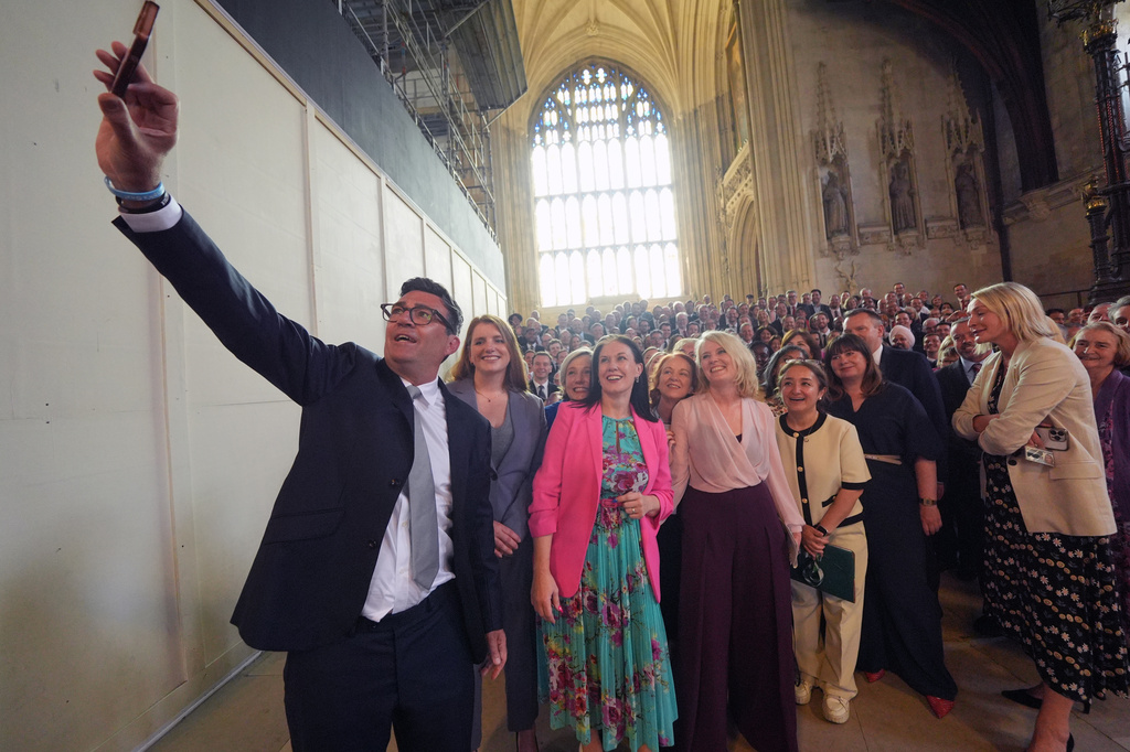 Andy Burnham with colleagues from the Parliamentary Labour Party in Westminster Hall at the Houses of Parliament in central London, as he returns to the House of Commons to take up his seat after winning the Makerfield by-election, Monday June 22, 2026. (Yui Mok/PA via AP)