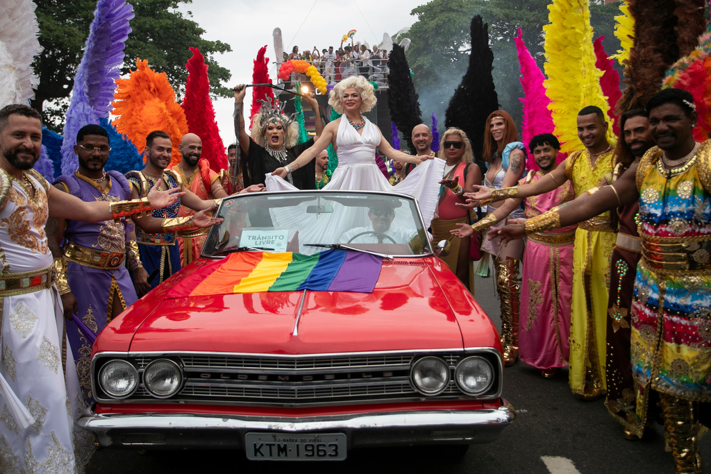 People celebrate the annual Rio Pride parade along Copacabana Beach in Rio de Janeiro, Sunday, Nov. 23, 2025. (AP Photo/Bruna Prado)