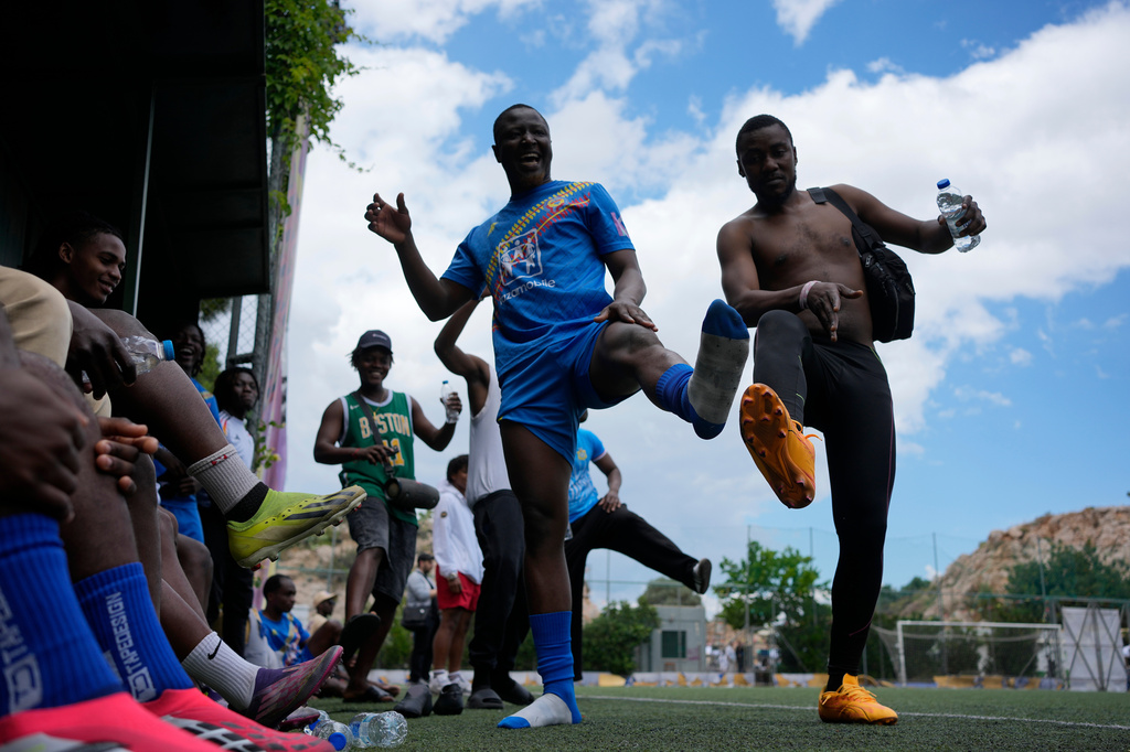 Migrants from Congo dance during a semifinal soccer match against Mali for the Kypseli Mundial in Athens,Greece, on Sunday, May 24, 2026. (AP Photo/Thanassis Stavrakis)