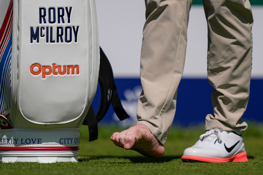 Rory McIlroy, of Northern Ireland, attends to his right foot on the fourth tee during a PGA Championship golf tournament practice round at Aronimink Golf Club, Tuesday, May 12, 2026, in Newtown Square, PA. (AP Photo/Matt Slocum)