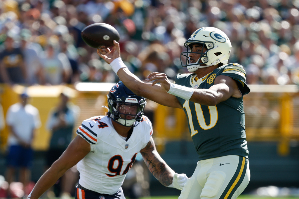Green Bay Packers' Jordan Love throws past Chicago Bears' Austin Booker during the first half of an NFL football game in Green Bay, Wis., Sunday, Oct. 11, 2026. (AP Photo/Mike Roemer)