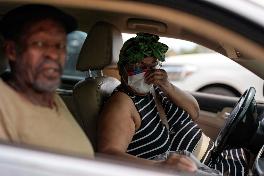 A taxi driver brings in a displaced man as the Pineland road fire in Brantley, county burns, Wednesday, April 22, 2026, in Nahunta, Ga. (AP Photo/Mike Stewart)