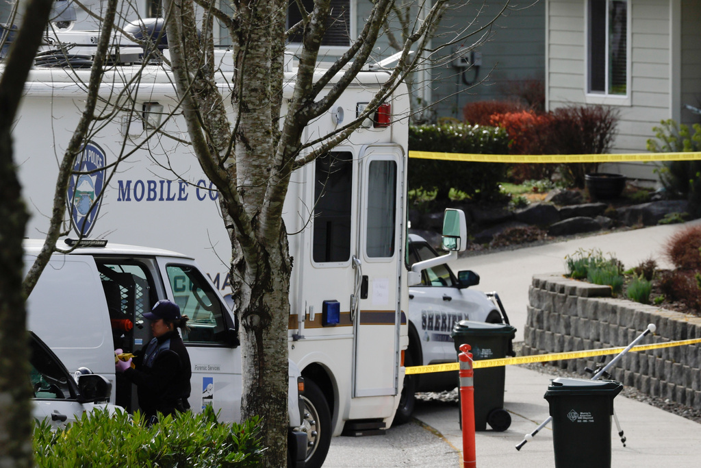 Authorities investigate the scene after reports that a man fatally stabbed multiple people Tuesday, Feb. 24, 2026, in Gig Harbor, Wash. (AP Photo/John Froschauer)