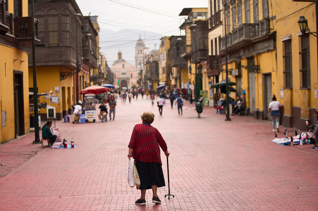 A woman walks through the Rimac district in Lima, Peru, Monday, June 8, 2026, a day after the presidential election runoff. (AP Photo/Rodrigo Abd)