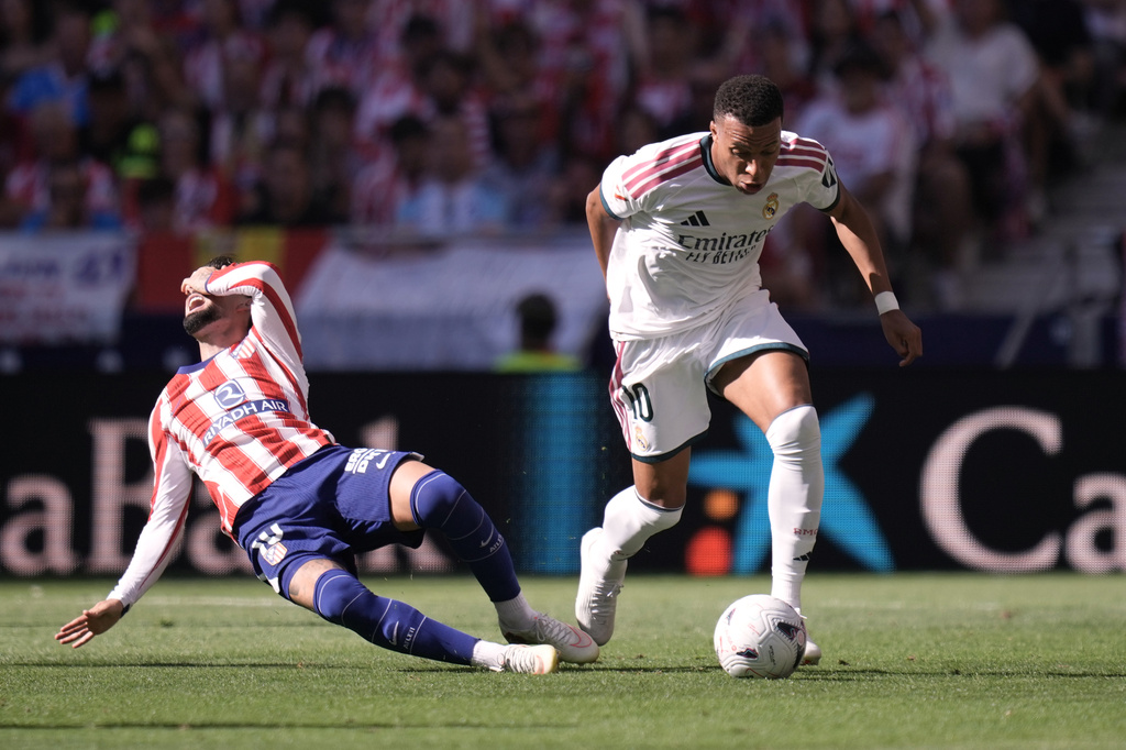 Atletico Madrid's Alex Baena falls to the ground in a clash with Real Madrid's Kylian Mbappe during a Spanish La Liga soccer match between Atletico Madrid and Real Madrid in Madrid, Sunday, Sept. 20, 2026. (AP Photo/Bernat Armangue)