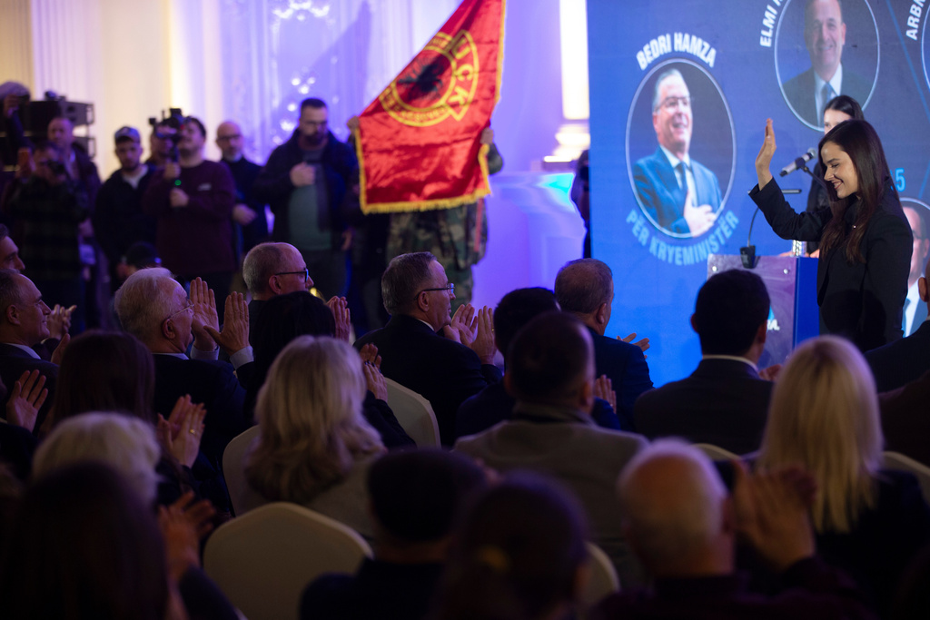 Leader of the PDK (Democratic Party of Kosovo) Bedri Hamza, center, aplauds at political candidates during election rally in the town of Ferizaj on Thursday, Dec. 25, 2025. (AP Photo/Visar Kryeziu)