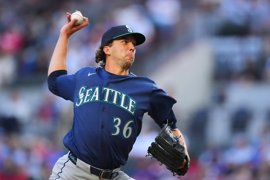 Seattle Mariners starting pitcher Logan Gilbert throws a pitch to the Texas Rangers during the first inning of a baseball game Monday, April 6, 2026, in Arlington, Texas. (AP Photo/Julio Cortez)