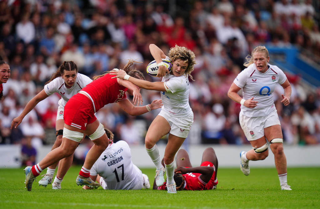 England's Ellie Kildunne is tackled by Canada's Rachel Smith during the WXV Global Series match between England and Canada in Exeter, England, Saturday Sept. 19, 2026. (David Davies/PA via AP)