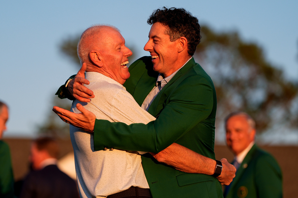 Rory McIlroy, of Northern Ireland, hugs his father Gerry McIlroy after winning the Masters golf tournament at the Augusta National Golf Club, Sunday, April 12, 2026, in Augusta, Ga. (AP Photo/Ashley Landis)