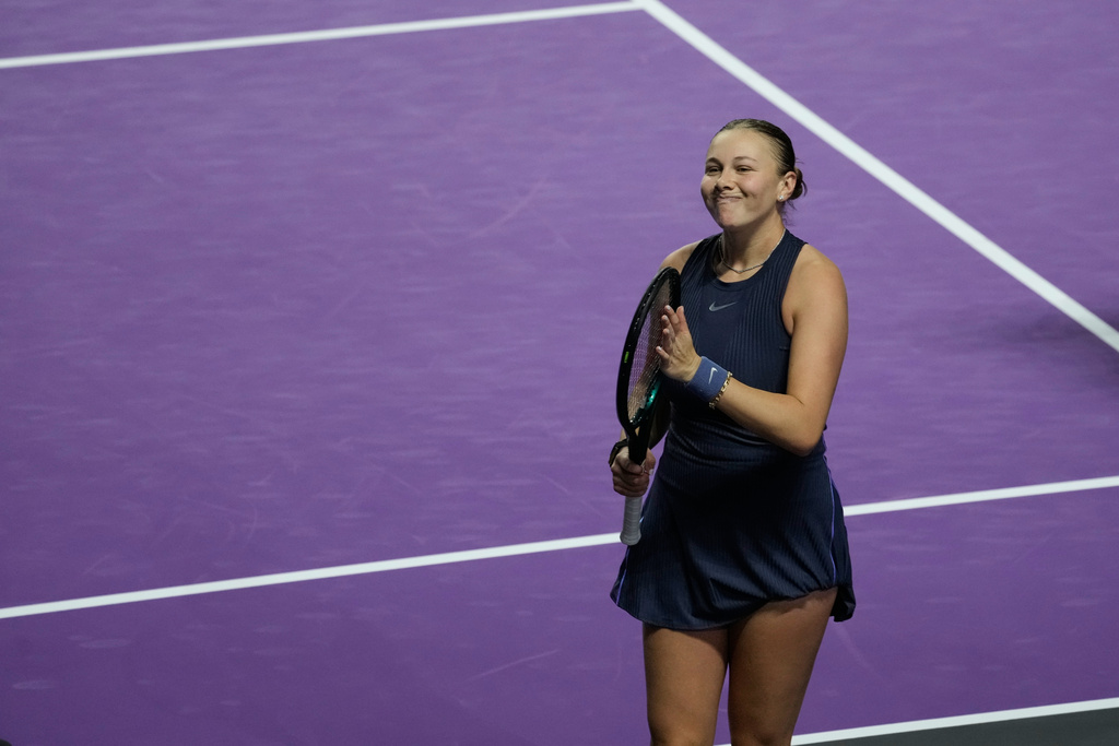 Amanda Anisimova of the United States celebrates after winning her women's singles match against Iga Swiatek of Poland at the WTA tennis finals in Riyadh, Saudi Arabia, Wednesday, Nov. 5, 2025. (AP Photo/Fatima Shbair)