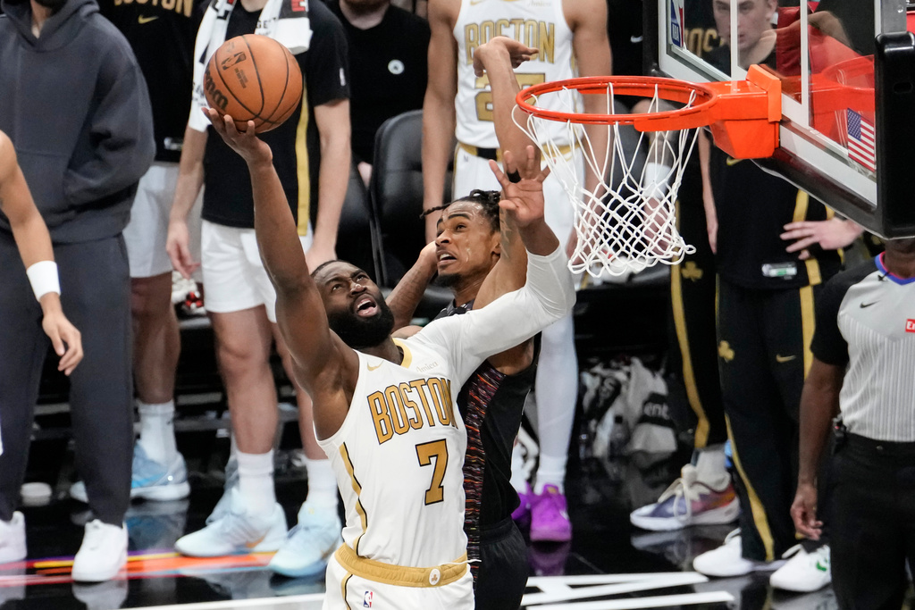 Boston Celtics guard Jaylen Brown (7) shoots over Brooklyn Nets center Nic Claxton, back, during the first half of an NBA basketball game, Friday, Jan. 23, 2026, in New York. (AP Photo/Yuki Iwamura)