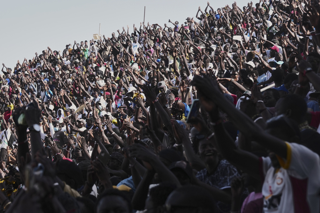 Fans cheer at a wrestling competition at the National Arena in Dakar, Senegal, Sunday, April 5, 2026. (AP Photo/Misper Apawu)