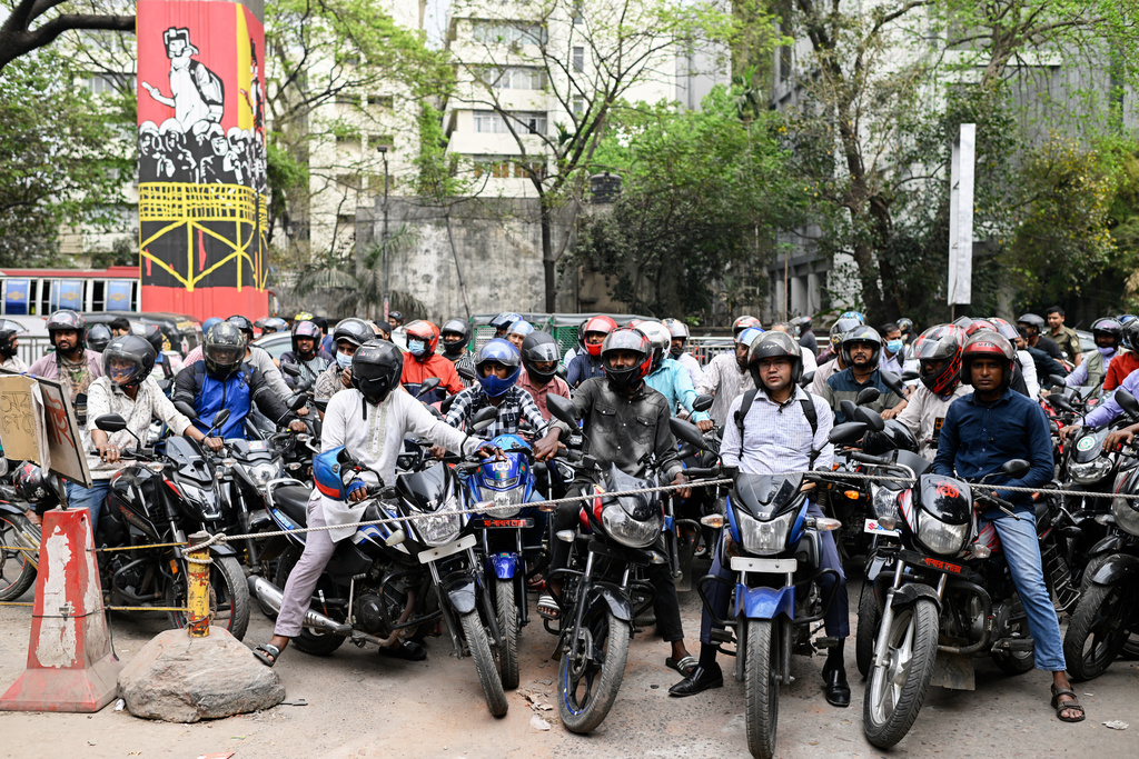 FILE - Motorists wait behind a rope for their turn to get fuel at a pump, fearing a possible fuel shortage due to the Iran war, in Dhaka, Bangladesh, Sunday, March 8, 2026. (AP Photo/Mahmud Hossain Opu, File)