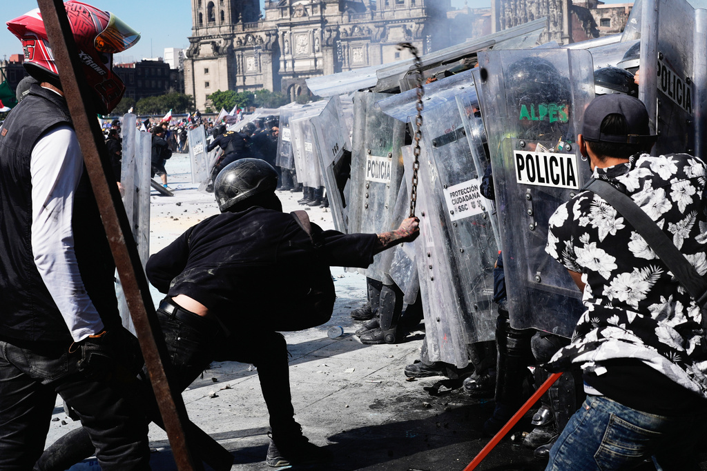 Protesters charge against police during a youth anti-government march in Mexico City, Saturday, Nov. 15, 2025. (AP Photo/Marco Ugarte)