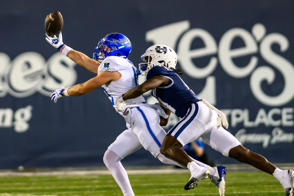 Air Force wide receiver Quin Smith (18) makes the one-handed catch defended by Utah State cornerback Bryson Taylor (11) during an NCAA college football game, Saturday, Sept. 13, 2025, in Logan, Utah. (AP Photo/Tyler Tate)