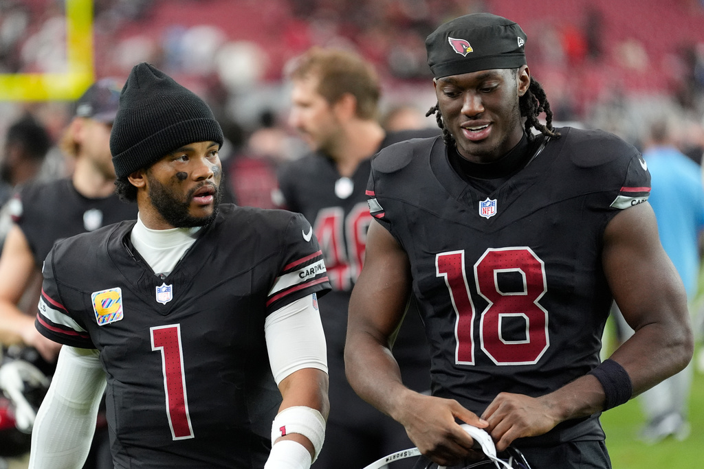 Arizona Cardinals quarterback Kyler Murray (1) and wide receiver Marvin Harrison Jr. (18) walk off the field after the team's loss in an NFL football game against the Tennessee Titans, Sunday, Oct. 5, 2025, in Glendale, Ariz. (AP Photo/Ross D. Franklin)