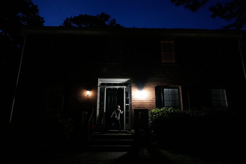 Malachi McNair-Nesbitt waits at the front door of his family's rental home in Jonesboro, Ga., before taking public transit with his family to Atlanta on June 11, 2025. (AP Photo/Brynn Anderson)