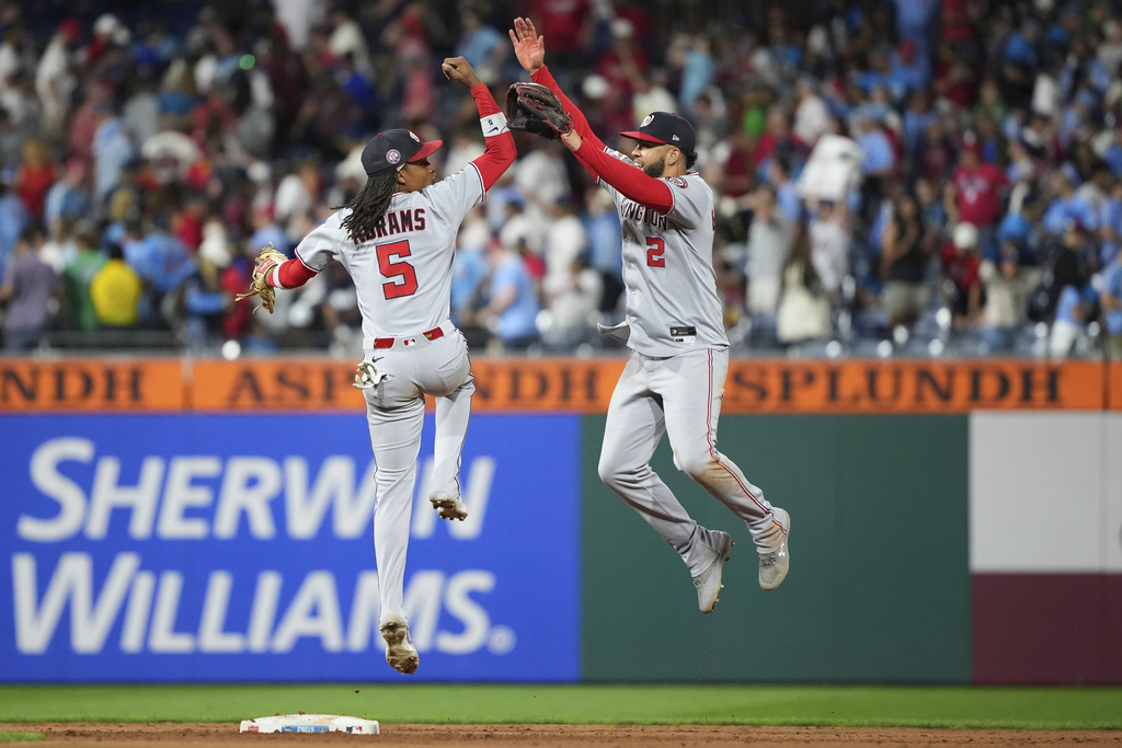 Washington Nationals' Luis García Jr., right, and CJ Abrams celebrate after the Nationals won a baseball game against the Philadelphia Phillies Friday, Aug. 22, 2025, in Philadelphia. (AP Photo/Matt Slocum)