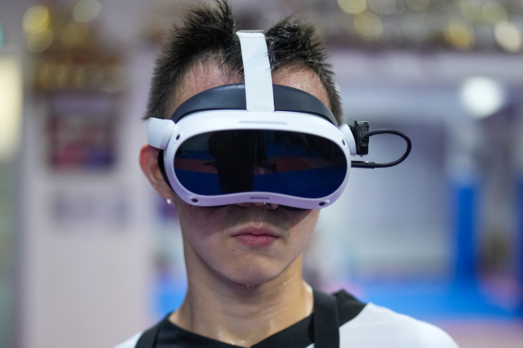 Jayden Teng, 15, trains using an immersive VR taekwondo system in Puchong, on the outskirts of Kuala Lumpur, Malaysia, Thursday, April 23, 2026. (AP Photo/Vincent Thian)