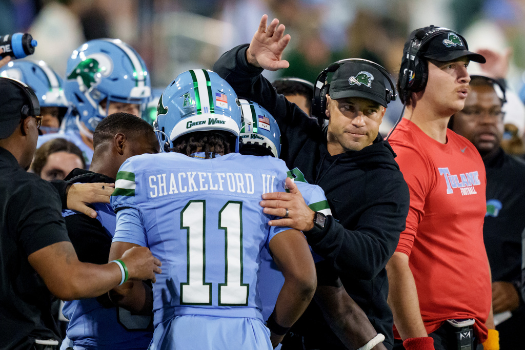 Tulane head coach Jon Sumrall encourages Tulane wide receiver Tre Shackelford (11) during the first half of an NCAA college football game against Charlotte in New Orleans, Saturday, Nov. 29, 2025. (AP Photo/Matthew Hinton)